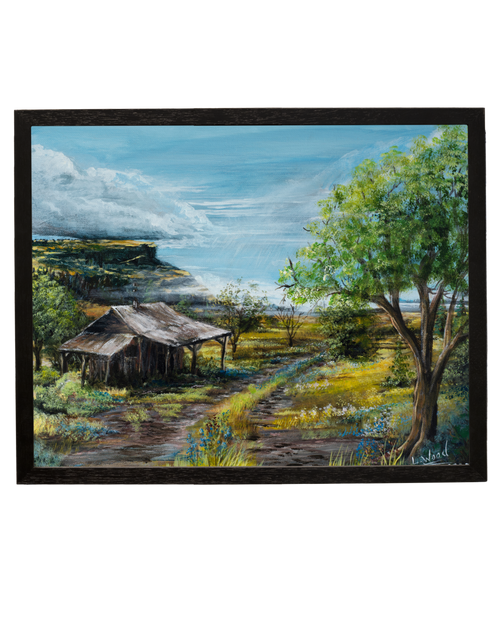 Framed fine art reproduction of Cabin Plateau, featuring a rustic cabin nestled beneath a sunlit tree with a winding path and dramatic plateau landscape, painted by Laura Fay Wood Cavaliere.